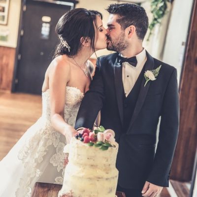 Couple cutting wedding cake at Avalon Castle